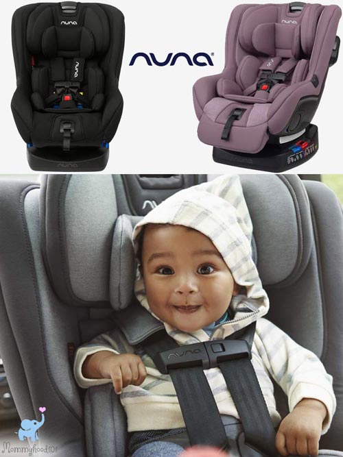 Nuna RAVA Convertible Car Seat baby sitting in a nuna rava car seat while smiling and leaning forward