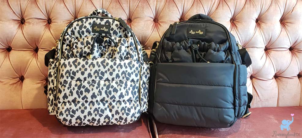 assorted itzy ritzy diaper bag backpack colors and patterns on a couch for testing