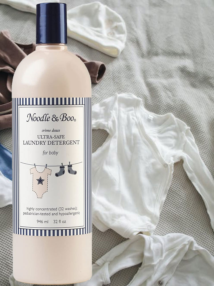 baby clothes next to a bottle of noodle and boo ultra-safe baby laundry detergent